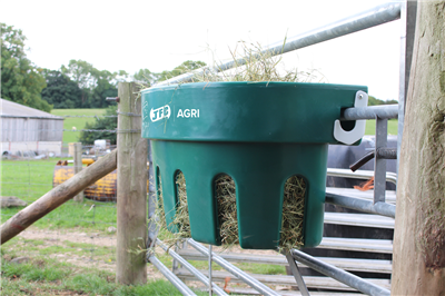 JFC Agri Gate Hay Feeder 100L hanging on a farm gate, green plastic 7-partition livestock feeder