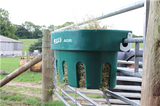 JFC Agri Gate Hay Feeder 100L hanging on a farm gate, green plastic 7-partition livestock feeder