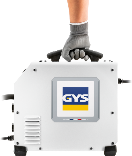 GYS EasyMIG 130 welder with accessories; white compact unit gripped by gloved hand on top handle