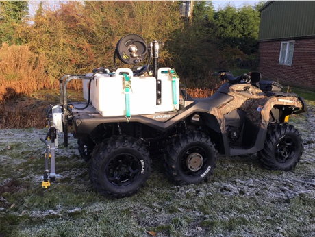 Fimco UTV Sprayer on a quad bike; white 246 L (65 gal) tank with green straps and a long spray boom.