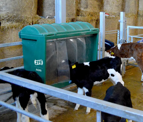 JFC Agri creep feeder 60kg gate livestock feeder with hinged lid; green metal unit feeding several cows.