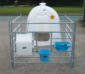 JFC Agri white large single calf hutch with front feeder, penning included, and blue feed bucket.