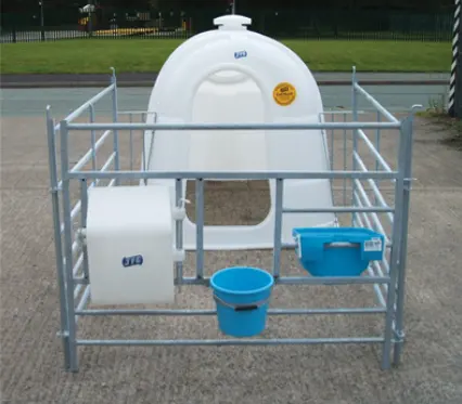 JFC Agri white large single calf hutch with front feeder, penning included, and blue feed bucket.