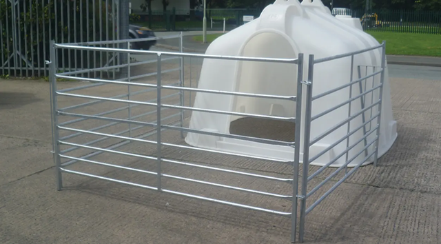Calf hutch by JFC Agri; white compact group housing with metal penning system