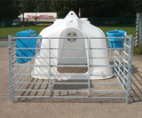 JFC Agri white compact calf hutch with metal pen and two blue feed troughs.