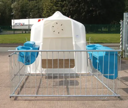 JFC Agri Super Calf Hutch White with two blue teat milk feeders mounted on a metal pen