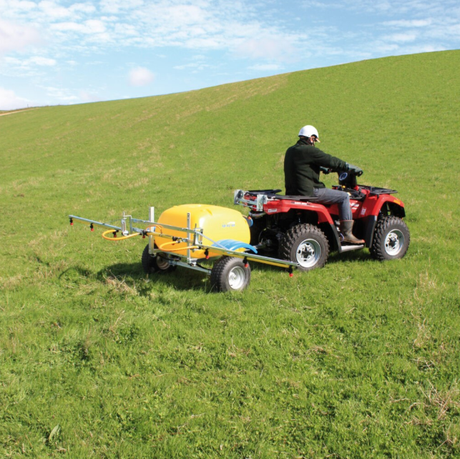 C-Dax Spray-On 200 Trailer Kit on a red ATV with a yellow sprayer tank, single-axle trailer.