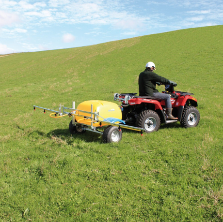 C-Dax Spray On 200 FD SO200 Gen 2 sprayer for ATVs, yellow tank on a trailer behind a red ATV