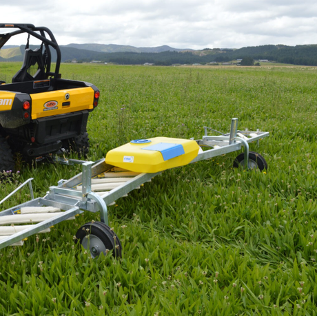 C-Dax Eliminator On-Board Tank 50L with 12V pump weed-wiper accessory on a metal trailer frame in a grassy field.