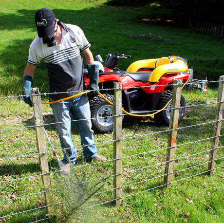 C-Dax SprayRider 50 G2 ATV sprayer; yellow 50L tank mounted on a red quad with an orange hose