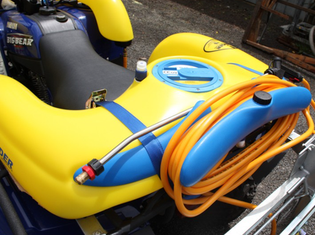 C-Dax SprayRider 50 G2 ATV spot sprayer mounted on a yellow and blue BigBear ATV with an orange coiled hose.