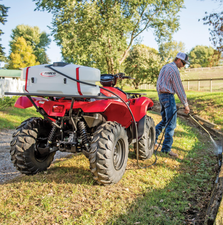 Fimco LG-15-EC ATV spot sprayer, 15-gallon white tank with red straps on a red ATV; 12V high-flow pump.