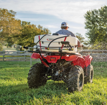 Fimco ATV Sprayer and Boom with 95L white tank mounted on a red ATV in a grassy field.