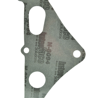Stator cover gasket, gray fiber material with mounting holes.