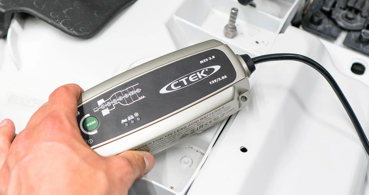 CTEK MXS 3.8 12V battery charger and maintainer; silver/black unit connected to a car battery with a green MODE button