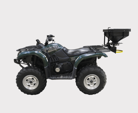 Fimco ATV Dry Material Spreader 12V DMS mounted on a green ATV with rear hopper and rain cover
