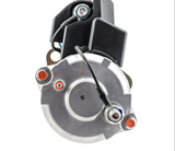 Denso gear reduction starter motor, 12V, 5.0kW, silver housing with black mounting bracket and red terminal posts.