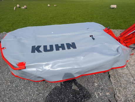 KUHN GMD 240-FF 2.4m disc mower under gray protective cover with red frame