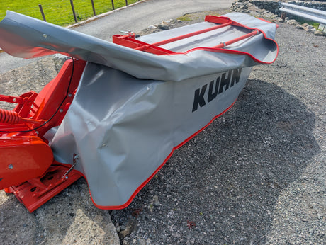 KUHN GMD 240-FF 2.4m disc mower, red frame with grey weather cover and KUHN branding.