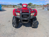 ATV Honda TRX 500 red front view with rugged bumper and large knobby tires