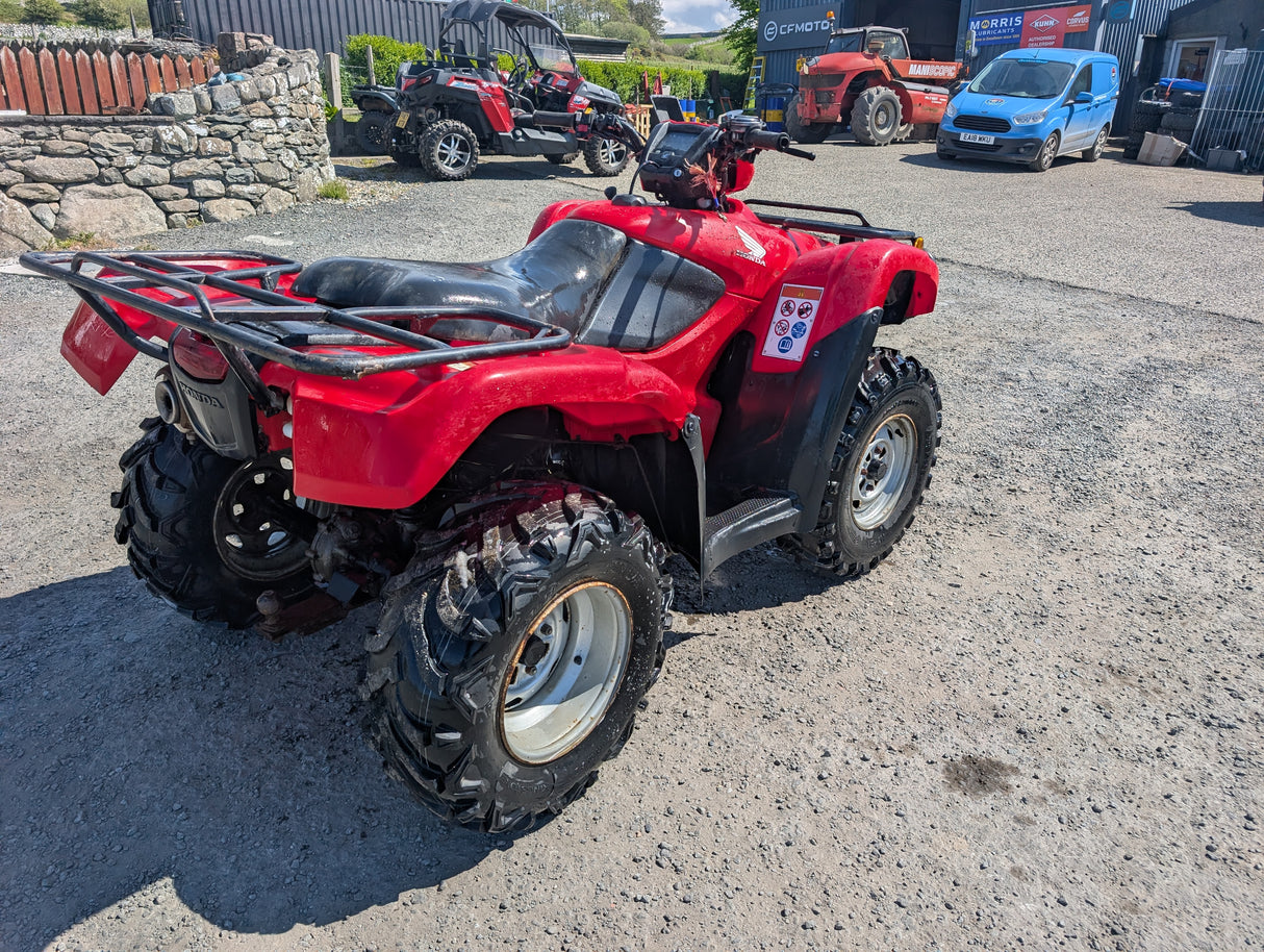 Honda TRX 500 ATV, red with black seat and rugged all-terrain tires