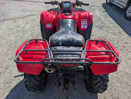 Honda TRX 500 ATV in red with black seat and front and rear cargo racks