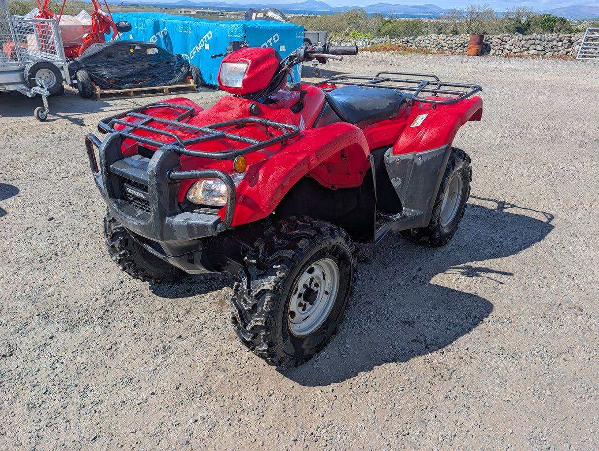 Honda TRX 500 ATV red quad with front rack and rugged tires