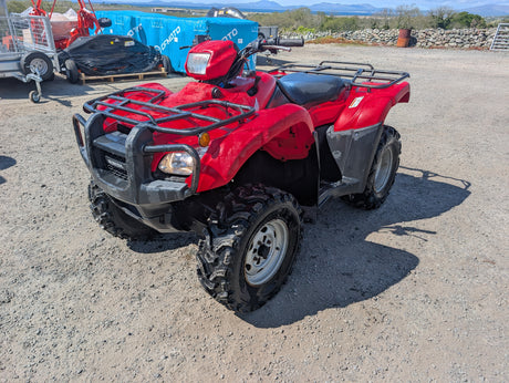 Honda TRX 500 ATV red quad with front rack and rugged tires