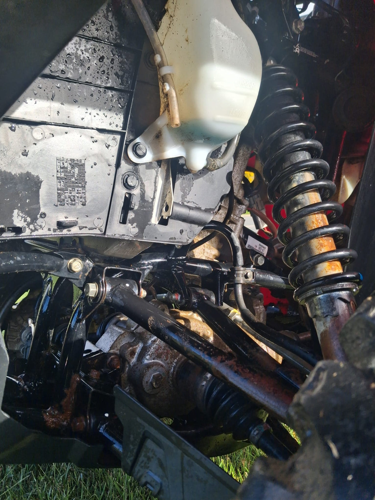 Honda TRX 520 FM6 manual ATV, used; black frame with rust and visible coil-spring suspension.