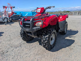 Honda TRX 500 ATV in red with black front bumper and rugged tires.