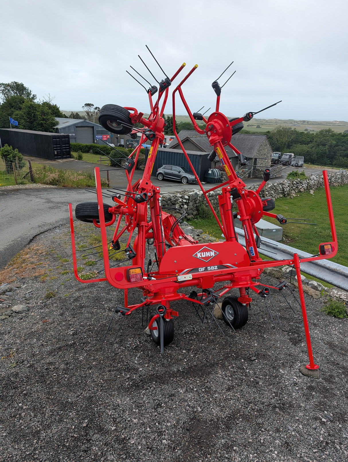 Kuhn GF582 6-rotor tedder in red for straw, hay and silage with KUHN logo visible