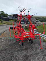 Kuhn GF582 6-rotor tedder in red for straw, hay and silage with KUHN logo visible