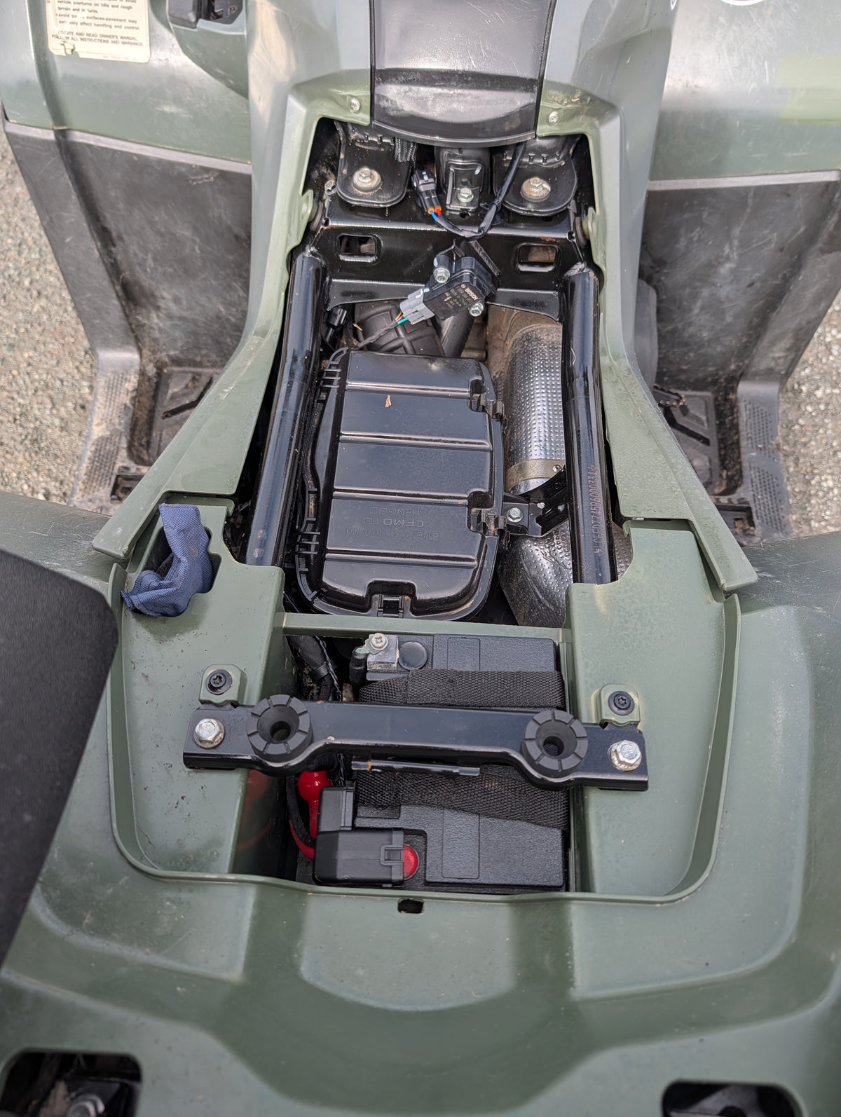Used CFMOTO CFORCE 520 ATV center console with exposed battery and wiring; green body panels
