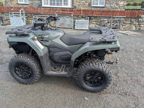 Used CFMOTO CFORCE 520 ATV with front and rear cargo racks, olive-green body, rugged off-road tires.